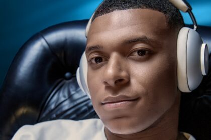 Kylian Mbappé wearing a pair of Loewe Leo headphones
