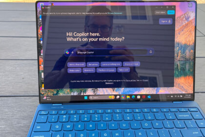 A Lenovo Yoga Slim 9i sitting on a picnic table outside