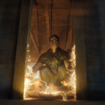 Chris Smith squatting down and looking up as the Quantum Unfolding Chamber door is relocated in Peacemaker season 2 episode 4