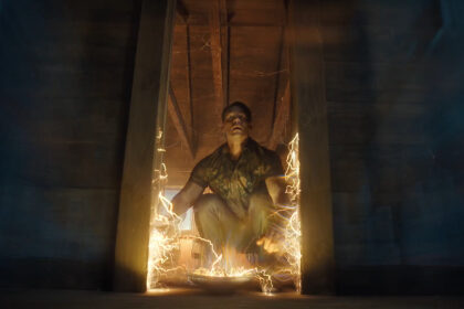 Chris Smith squatting down and looking up as the Quantum Unfolding Chamber door is relocated in Peacemaker season 2 episode 4