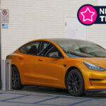 A Tesla car being recharged at a Shell Recharge station