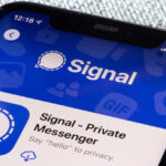 A smartphone on a table showing the Signal app