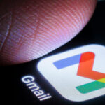 Gmail app on a phone with a thumb hovering above