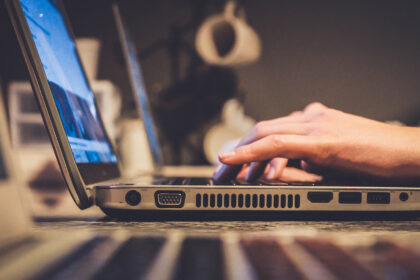 person typing on laptop