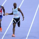 Letsile Tebogo (C) of Team Botswana crosses the finish line to win the gold medal in the Men's 200m Final on day thirteen of the Olympic Games Paris 2024 at Stade de France on August 08, 2024 in Paris, France.