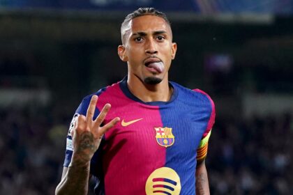 Raphinha of FC Barcelona celebrates scoring his team's fourth goal and his hat-trick goal during the UEFA Champions League 2024/25 League Phase MD3 match between FC Barcelona and FC Bayern Munchen at Estadi Olimpic Lluis Companys on October 23, 2024 in Barcelona, Spain.