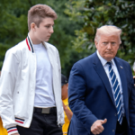Donald Trump walks alongside his son Barron Trump outdoors, with onlookers in the background, during a public appearance.