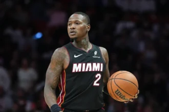 Miami Heat player dribbling the basketball during an NBA game while wearing a black jersey with the number 2.