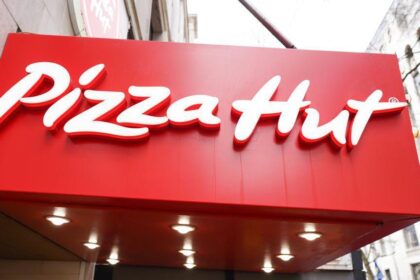 Pizza Hut logo and signage displayed above the entrance of a UK restaurant.