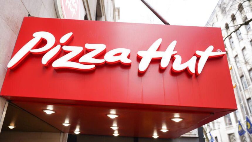 Pizza Hut logo and signage displayed above the entrance of a UK restaurant.