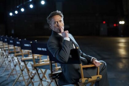 Robert Downey Jr sitting in a chair and holding a finger to his lips during Marvel's Avengers: Doomsday cast reveal