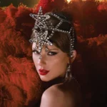Taylor Swift dressed as a glamorous showgirl, posing confidently for the camera in sparkling stage attire.