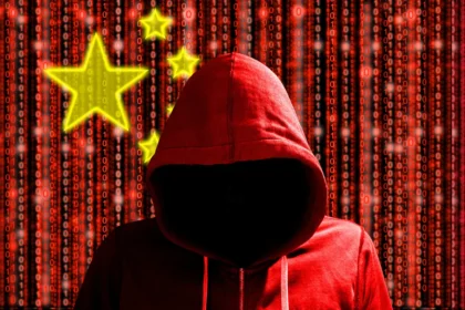 Dark hooded figure with the Chinese flag in the background, symbolizing Chinese spies and hackers targeting the UK.
