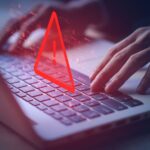 Laptop with warning symbols over the keyboard