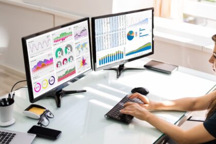 Woman using multiple monitors at a desk