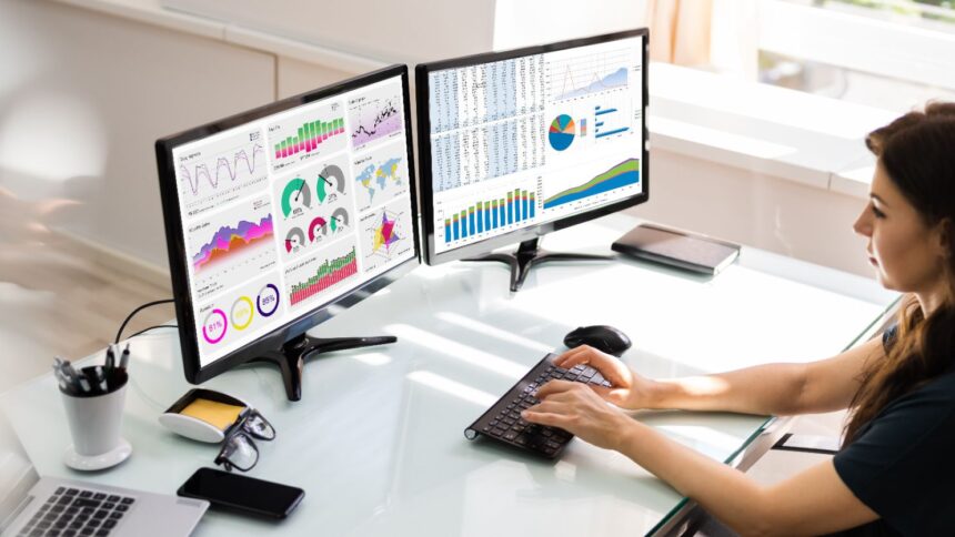 Woman using multiple monitors at a desk