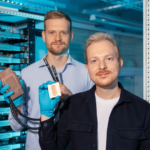FOUNDERS - Corintis founders (Sam Harrison, Co-Founder, COO- Left, Remco van Erp, CEO - Right) holding Cold plate (left) and Microfluidic core (right)