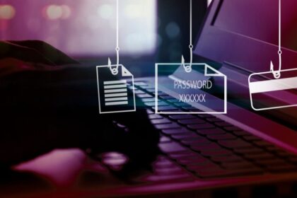 Image depicting hands typing on a keyboard, with phishing hooks holding files, passwords and credit cards.