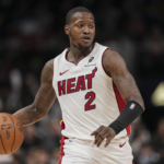 Terry Rozier dribbles the ball up the court while wearing a Miami Heat jersey during an NBA game.