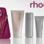 RHODE skincare and makeup products neatly arranged, featuring creams, serums, and cosmetics in minimalist packaging reflecting the brand’s luxury aesthetic.