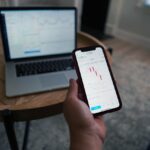 A man checking his smartphone to see his investment