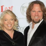 Janelle Brown and Kody Brown posing together on the red carpet at a Sister Wives event, smiling for photographers.