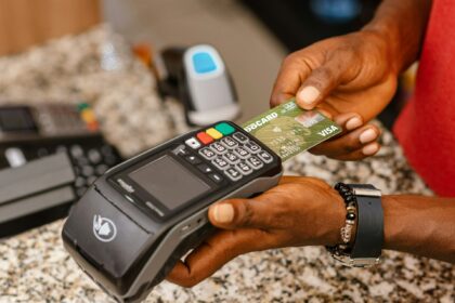 a person holding a credit card in their hand