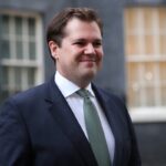 Robert Jenrick looking smug outside 10 Downing Street.